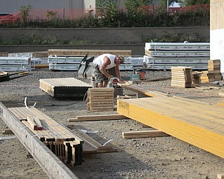        ROBERT K. YOSAY  | THE VINDICATOR..Cutting wood beams to fit.. DAV construction is the GC for the Holiday Inn Express ..The city of Salem received more than $1.85 million from leasing rights on city property, said Mayor John Berlin. Salem used $650,000 to pay down debt from the cities efforts to revitalize the downtown and improve roads for economic development..The hotel will be the only one in Salem and represents just a part of the economic development in the city....  -30-       ROBERT K. YOSAY  | THE VINDICATOR...  -30-