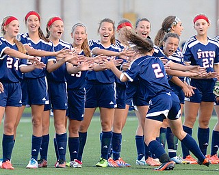 Jeff Lange | The Vindicator  Kaelyn Puhalla (2) of Fitch high fives her teammates during pre game announcements of Monday night's soccer game in Canfield.