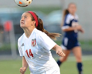 Jeff Lange | The Vindicator Canfield sophomore Alana Petracci heads the ball toward the goal, Monday night during the Cardinal's matchup with Austintown Fitch in Canfield.