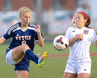 Jeff Lange | The Vindicator  Fitch's Sam Sheely kicks the ball past the defense of Canfield's Alana Petracci during their Monday night contest in Canfield.