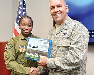 Javionte Allen, 13, of Warren, accepts his certificate from Air Force Col. James Dignan after the eighth-grader was sworn in Wednesday as an honorary second lieutenant and 910th Pilot for a Day at the Youngstown Reserve Air Station in Vienna.