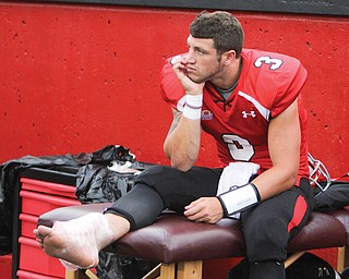 Youngstown State starting quarterback Dante Nania sits on the sidelines with ice on his ankle after being injured in the fourth quarter of last Saturday’s home opener against Duquesne at Stambaugh Stadium. Nania sat out of practice Tuesday and Wednesday and may be out for Saturday’s game against Butler.