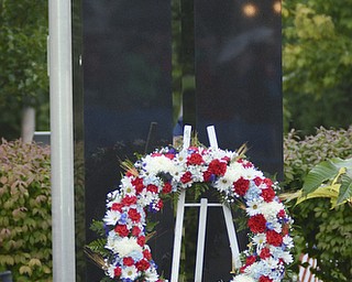 Katie Rickman | The Vindicator.A wreath on sits in front of a memorial replica of the twin towers on display at the 911 memorial park in Austintown during the 13-year memorial service Sept. 11, 2014.