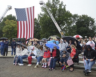 Katie Rickman | The Vindicator.A large flag hands from fire ladders at the 911 memorial park as local residents attend a ceremony marking the 13th anniversary Sept, 11, 2014.