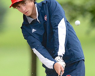 Jeff Lange | The Vindicator  Fitch senior Dominic Ignazio blasts his way out of the bunker on the tenth green during Thursday's golf outing against Boardman at Deer Creek Golf Course.