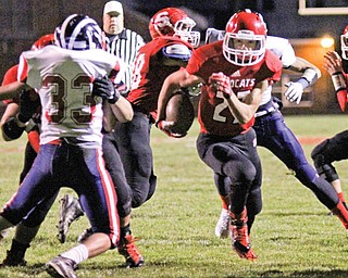 Struthers senior Lukasz Witkowski (27) runs through a hole against the Niles defense in a game last season. Witkowski, by OHSAA rule, can return to the field this week after sitting out the first two games of the season.