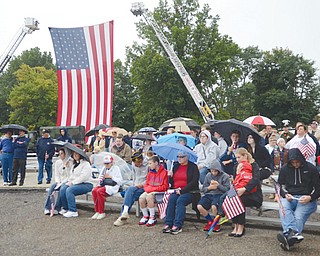 An American flag hangs from ladder trucks at the Mahoning Valley 9/11 Memorial Park in Austintown. The memorial park on Thursday was the site of a ceremony to mark the 13th anniversary of the Sept. 11, 2001, terrorist attacks.