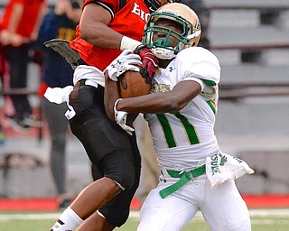 Jeff Lange | The Vindicator  Ursuline's Marcus Mosley is immediately brought down by Big Red defender Mandela Lawrence-Burke after receiving a pass in the first quarter at Harding Stadium, Friday night.