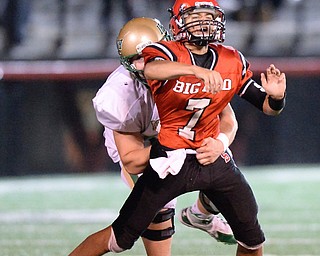 Jeff Lange | The Vindicator  Ursuline's Glacamo Cappabianca brings down Steubenville's Dimitri Collaros from behind as he gets rid of the ball late in the first half at Harding Stadium, Friday night.