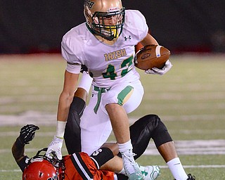 Jeff Lange | The Vindicator  Ursuline's John Martynyszyn is tripped up by Big Red defender Shyoun Petteway late in the first half in Steubenville, Friday night.