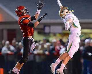 Jeff Lange | The Vindicator  John Martynyszyn of Ursuline stretches out in attempt to swat the ball away from Big Red's Lucas Herrington in the second quarter of their matchup in Steubenville.