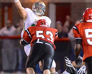 Jeff Lange | The Vindicator  Ursuline QB Vito Penza get rid of the ball before Seth Blacco of Steubenville was able to get to him, in the second quarter of Friday night's matchup in Steubenville.