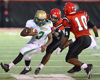 Jeff Lange | The Vindicator  Kimauni Johnson of Ursuline rushes for yardage as he is brought down by Steubenville's Johnnie Blue late in the first half at Harding Stadium, Friday night.