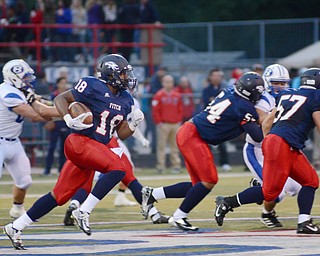 Katie Rickman | The Vindicator .Fitch's Antwan Harris follows his blockers DeAndre Henry (54) and J.D. Vaught (57) around the right side during the game against Brunswick at Fitch High School Friday, Sept. 12, 2014 in Austintown, Ohio