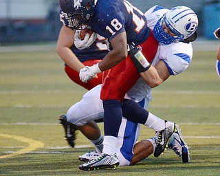 Katie Rickman | The Vindicator .Fitch's Antwan Harris is tackled by Brunswick's Eliot Laisure during the first quarter at Fitch High School Sept. 12, 2014.