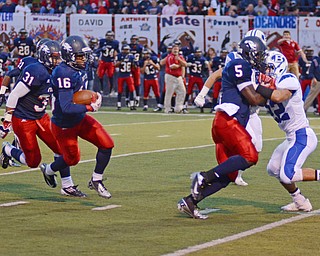 Katie Rickman | The Vindicator .Fitch's Carlos Herriott blocks  Joe Pinzone (22) as Nick Davis runs around the right side during the first quarter against Brunswick at Fitch High School Sept. 12, 2013.