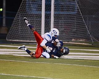 Katie Rickman | The Vindicator .Fitch's Joey Harrington scores six points while being tackled by Brunswicks Zach Stepp during the first quarter at Fitch High School Sept 12, 2014.