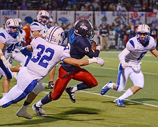 Katie Rickman | The Vindicator .Fitch's Joey Harrington runs away from Adam Nickles (32) before he is tackled by Tim Dick (6) during the 1st quarter at Fitch High School Sept 12, 2014..