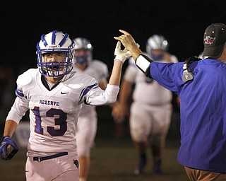  .          ROBERT  K. YOSAY | THE VINDICATOR..Western Reserve  Wyatt Larimer gets a High Five from Coach Andy Hake  after Wyatt caught a pass for a TD late in the second quarter .Western Reserve at South Range Stadium...-30-