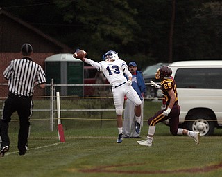  .          ROBERT  K. YOSAY | THE VINDICATOR..First Blood as Western Reserve's @#13  Wyatt Larimer one handed a Pass in the end zone to take a 7-0 Lead in the first quarter- as Defender #25  South Range  Nick Stanton..Western Reserve at South Range Stadium...-30-