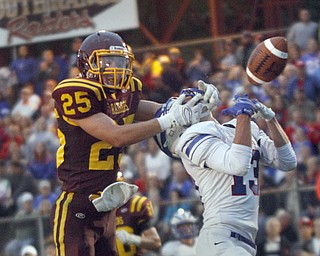  .          ROBERT  K. YOSAY | THE VINDICATOR..Breaking up a pass is #25 Raider Nick Stanton pulls back on the head of  #13 Wyatt Larimer  in the endzone during Second quarter action - there was a penalty ...Western Reserve at South Range Stadium...-30-