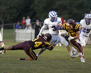  .          ROBERT  K. YOSAY | THE VINDICATOR..Western Reserve #3 EvanNesbitt break s around end as  Raiders #34 David McCabe and  #25  Nick Stanton try to stop him .. behind them is  Reserves #25 Brian Sunderman..Western Reserve at South Range Stadium...-30-