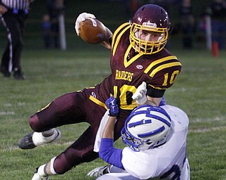  .          ROBERT  K. YOSAY | THE VINDICATOR..Raiders #10 Greg Dunham  gets pulled down by Reserves  Jack Cappabianca  #34  after getting a first down during second quarter action..Western Reserve at South Range Stadium...-30