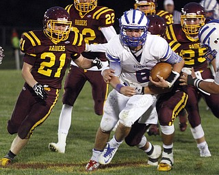  .          ROBERT  K. YOSAY | THE VINDICATOR..Leader of the pack for a first down as  Reserves' #8  Aaron Posten breaks through the line as he is being held by Raiders #19  Ryan Miller  --l-r  #21  JR Renforth  #22  Ben Baird  #25  Nick Stanton..Western Reserve at South Range Stadium...-30-