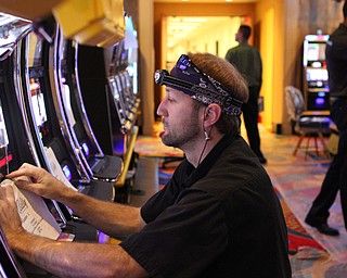 Madelyn Hastings...Brandon Severs...  Bally Technologies works on a gaming machine.