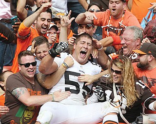 Browns center Alex Mack jumps in the Dawg Pound with fans to celebrate Cleveland’s last-second win over the New Orleans Saints in their home opener Sunday at FirstEnergy Stadium in Cleveland. Kicker Billy Cundiff hit a 29-yard field goal with three seconds left to give the Browns the 26-24 win.