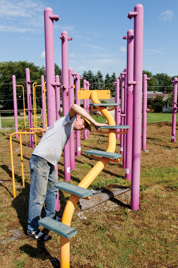 Tim Sokoloff, president of the Iron Soup Historical Preservation Co., inspects bolts before dismantling the last of the playground installed in 2003 on the grounds of St. Joseph the Provider, 633 Porter Ave., Campbell. Earlier this year, the playground’s placement was deemed unsafe, so Christ the Good Shepherd Parish is donating the equipment to ISHPC.