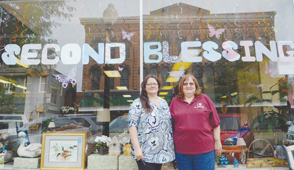 Chris Baker, left, and Marilee Bodendorfer , a volunteer, stand outside the Second Blessing thrift shore, 146 S. Broadway, Salem. The store was started by Faith Chapel Fellowship, and proceeds benefit its ministries and the community .