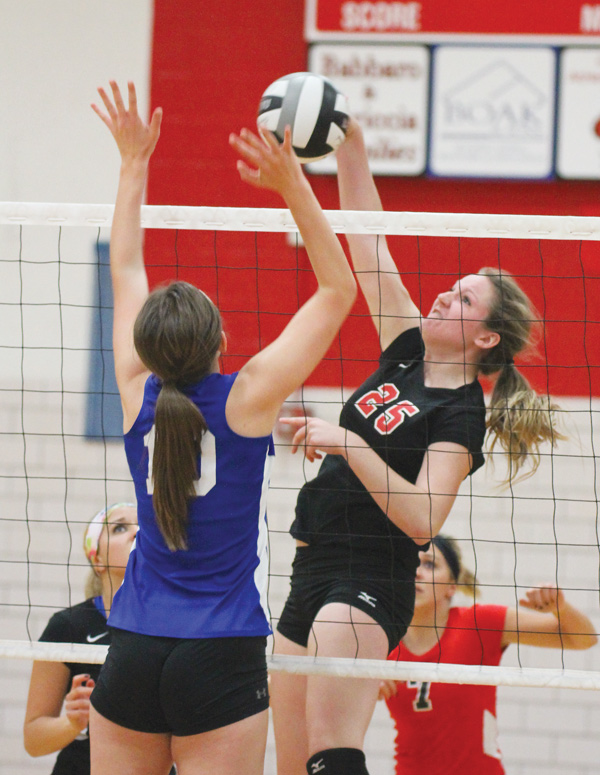 Canfield’s Maddy Johns (25) returns the ball past Poland’s Arlia Duarte (10) during Monday’s volleyball match at
Canfield High School. Canfield won in three games.