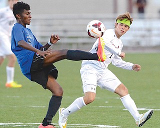 Canfield’s Christian Hume ducks as CVCA’s Andrew Akindipe kicks the ball over him during first-half play in Tuesday’s game in Canfield.