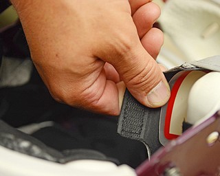 Katie Rickman | The Vindicator.Boardman High School football Assistant Athletic Director Nick Hewko shows how the insert lines a football helmet. Boardman High School football team is now using the Riddell Impact Response System which will allow coaches to monitor players impact on field during practices and games on Wednesday, Sept. 17, 2014 at Boardman High School.