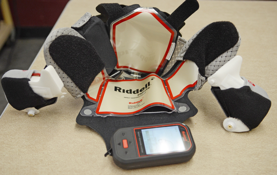 Katie Rickman | The Vindicator.Boardman High School football team has begun using Ridell Impact Response System technology that allows the coaching staff to monitor and prevent concussions Wednesday, Sept. 17, 2014. Seen here is a device that coaches use to keep track of what the player is experiencing when coming in contact with other players. Inside 6 helmets, an electrical pad is inserted which allows coaches to monitor the players impact.