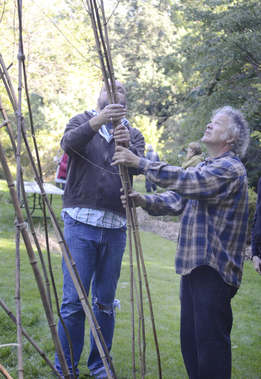 Katie Rickman | The Vindicator.Local sculptor Tony Armeni, on right, looks up at the bamboo as John Noga holds it in place at Fellows Riverside Garden on Wednesday, Sept. 17, 2014.