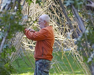 Katie Rickman | The Vindicator.Teddy Barritt of Niles stands on the inside of the structure being put together at Fellows Riverside Garden Wednesday, Sept. 17, 2014. Barritt is a member of the Master Gardener Program at Fellows Riverside Garden.