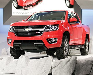 The new 2015 Chevrolet Colorado is introduced at the Los Angeles Auto Show in Los Angeles. Early demand is so high for the new Colorado and GMC Canyon pickup trucks that General Motors is hiring more workers to build them even before one is sold to the public.