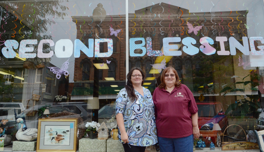 Katie Rickman | The Vindicator.Chris Baker (left), manager of Second Blessing stands with volunteer Marilee Bodendorfer outside of the store on Wednesday, Sept. 9, 2014 in Salem, Ohio. The store is run by mostly volunteers who put in hours even after the store has closed for the day. ..