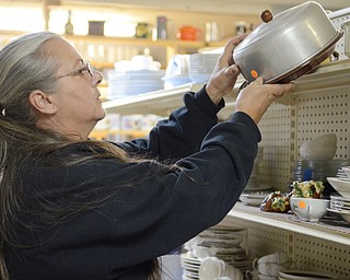Katie Rickman | The Vindicator Terri Ossler of Augusta drives roughly 25 minutes to Salem once a month with her husband Jim to look through the merchandise at Second Blessing.  She sorts through the kitchen appliances and looks for glassware on Wednesday, Sept. 10, 2014 in Salem, Ohio