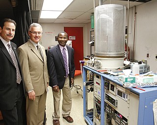        ROBERT K. YOSAY  | THE VINDICATOR..Martin Abraham Dean- President Jim Tressel - and  Tom Oder - Youngstown State University physics professor achieved a first for the university: a federal patent. behind him is President Jim Tressel ... -30-