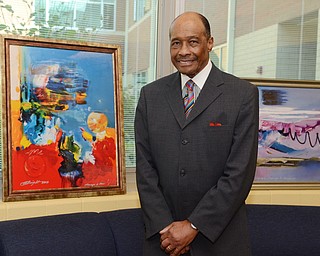 Katie Rickman | The Vindicator .Al Bright poses for a photo in front of his artwork at William Holmes McGuffey Elementary School where he received the Pioneer Award art during the Founder’s Day Program Friday, Sept. 19, 2014.