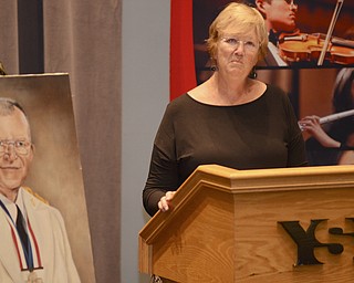 Katie Rickman | The Vindicator.Janne Hurrelbrink speaks while standing next to a portrait of her father Donal Hurrelbrink during the scholarship announcement ceremony at Bliss Hall Friday, Sept. 19, 2014.