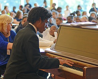 Katie Rickman | The Vindicator .Michael Nichols, who is studying at YSU Dana School of Music, plays three songs for the students at Willam Holmes McGuffey Elementary Elementary School for the Founder’s Day Program on Friday, Sept. 19, 2014 in Youngstown.