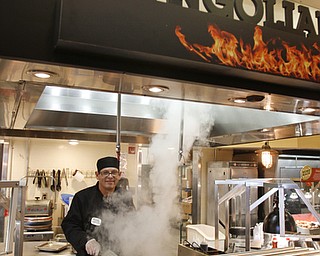        ROBERT K. YOSAY  | THE VINDICATOR..Mongolian Grill chef Candido Cartagena  cooks up some fresh food as the Golden Corral reopened in Boardman .. -30-