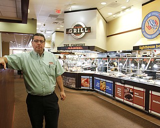       ROBERT K. YOSAY  | THE VINDICATOR.. William Sarmiento. manager -  ..Mongolian Grill chef Candido Cartagena  cooks up some fresh food as the Golden Corral reopened in Boardman .. -30-