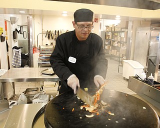        ROBERT K. YOSAY  | THE VINDICATOR..Mongolian Grill chef Candido Cartagena  cooks up some fresh food as the Golden Corral reopened in Boardman .. -30-