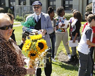        ROBERT K. YOSAY  | THE VINDICATOR..Lucille Vegh holds flowers during the ceremony rededicating the peace pole Rabbi Joseph P. Schonberger officiated. Lucille is Bill Vegh wife .the pole is inhonor of him.. -30-