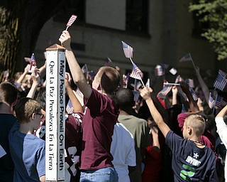        ROBERT K. YOSAY  | THE VINDICATOR..Boardman Middle School ... students wave flags as a re-dedication of a Òpeace poleÓ  in front of Boardman Center Middle School in honor of World Peace Day. The pole was originally dedicated in honor of a Holocaust survivor, whose daughter will attend the ceremony.. -30-